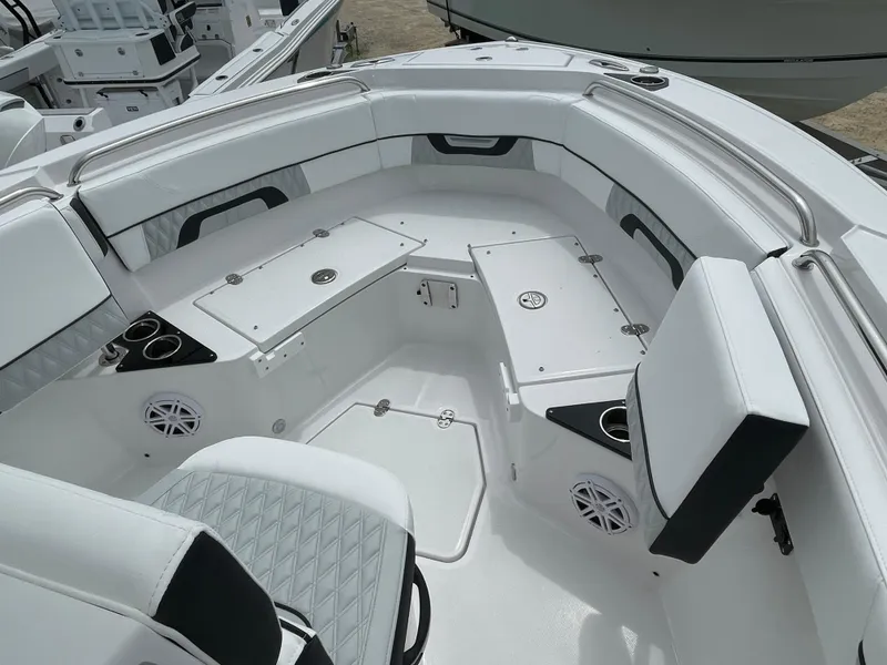 Slide: The Image of 2026 Blackfin 222CC boat interior with white seating, cup holders, and storage compartments. - 6
