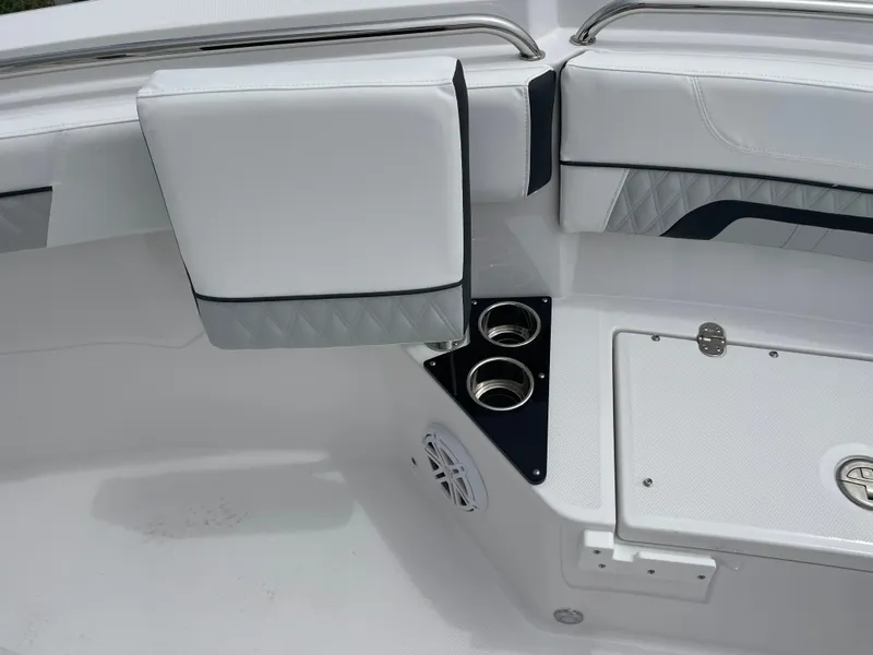 Slide: The Image of 2026 Blackfin 222CC boat interior with white seating and cup holders. - 8