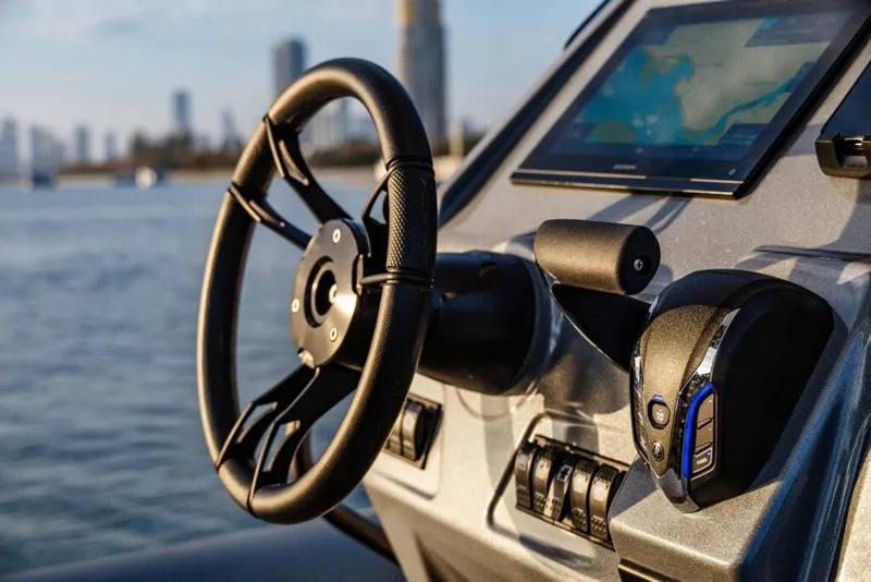 Slide: The Image of 2025 Grand Inflatables G750 boat dashboard with steering wheel and navigation screen. - 6