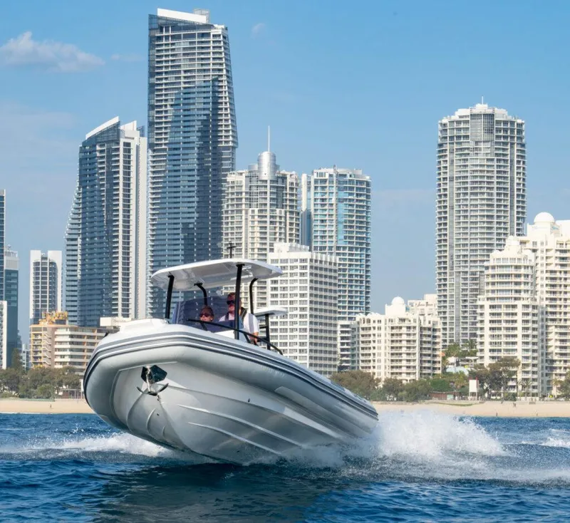 Slide: The Image of 2025 Grand Inflatables G750 boat cruising near city skyscrapers. - 7