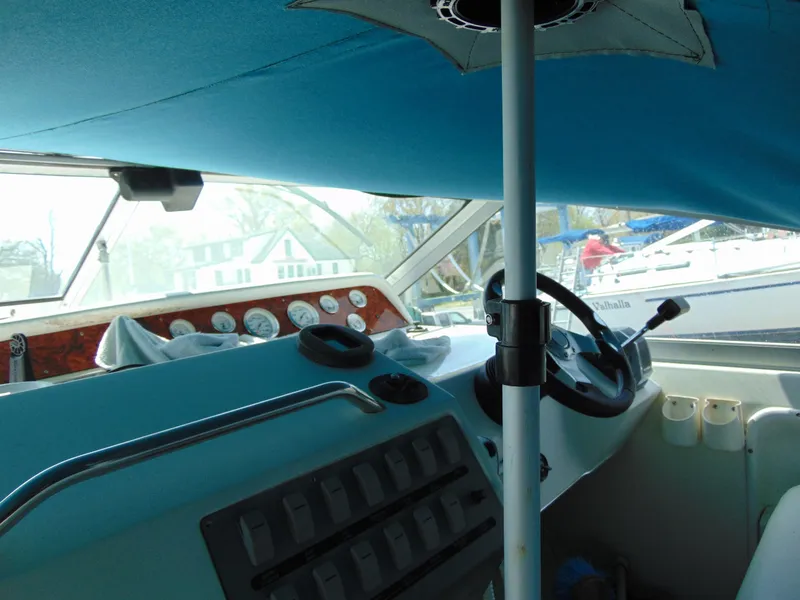 Slide: The Image of Interior view of 1996 Sea Ray 290 boat cockpit with steering wheel and control panel. - 3