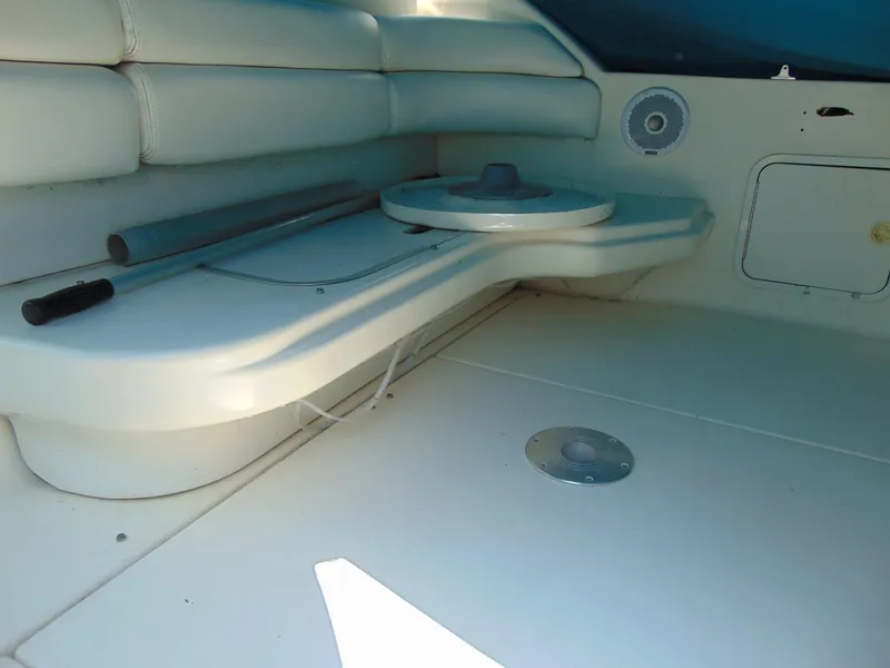Slide: The Image of Interior of a 1996 Sea Ray 290 boat, featuring white seating and a compact table. - 4