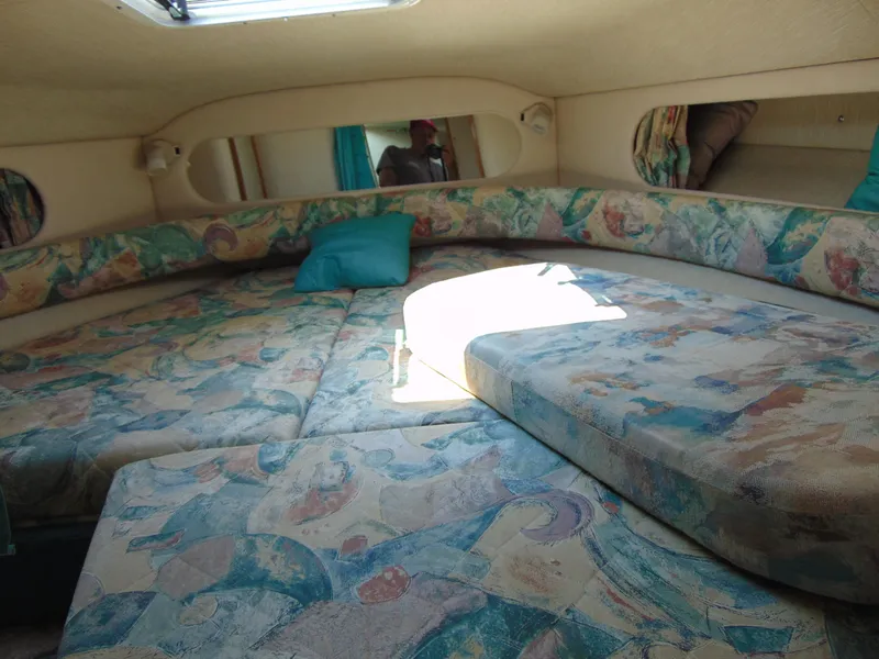 Slide: The Image of 1996 Sea Ray 290 cabin interior with patterned cushions and natural light. - 5