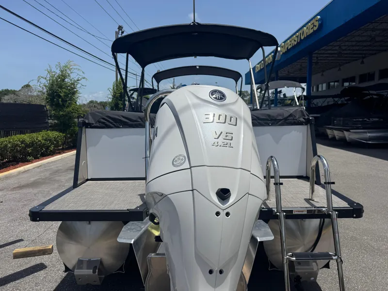 Slide: The Image of 2025 Avalon Catalina Platinum Quad Lounge boat with powerful 300 V6 engine, docked outdoors. - 5
