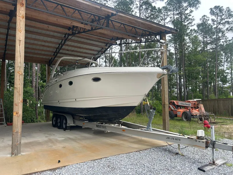 Slide: The Image of 2007 Chaparral Signature 330 boat on trailer under a wooden shelter. - 3