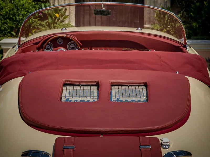 Slide: The Image of 2025 Seven Seas Yachts Venus Speedster interior with red upholstery and classic dashboard design. - 6