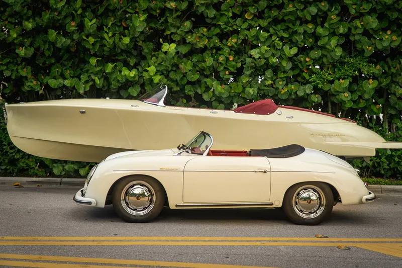 Slide: The Image of Classic car parked beside 2025 Seven Seas Yachts Venus Speedster, lush greenery background. - 2