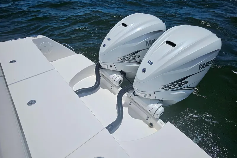 Slide: The Image of Twin Yamaha outboard engines on 2019 Everglades 335 Center Console boat in open water. - 13