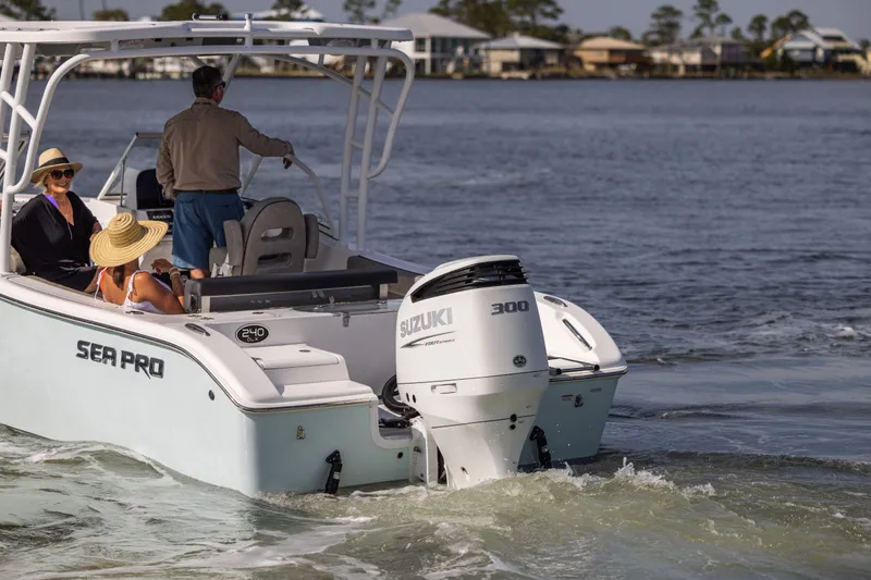 Slide: The Image of 2025 Sea Pro 240 Dual Console boat cruising on water with passengers enjoying the ride. - 7
