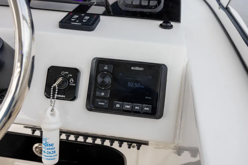 Slide: The Image of Dashboard of 2025 Sea Pro 240 Dual Console with audio system and ignition key. - 8