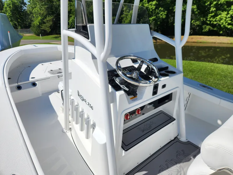 Slide: The Image of 2025 BlackJack 256 Coastal boat interior with steering wheel and control panel. - 15