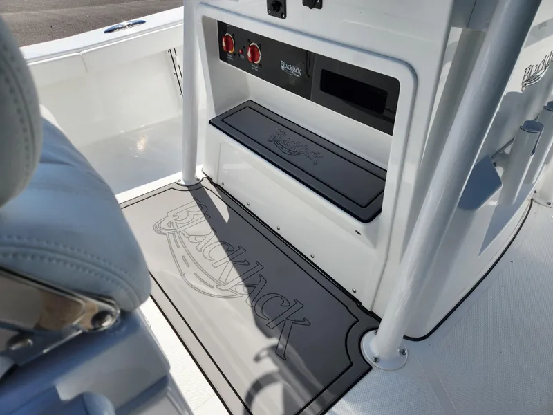 Slide: The Image of 2025 BlackJack 256 Coastal boat interior with branded flooring and control panel. - 17
