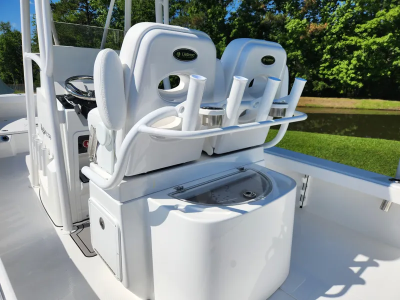 Slide: The Image of 2025 BlackJack 256 Coastal boat interior with seating and rod holders. - 20