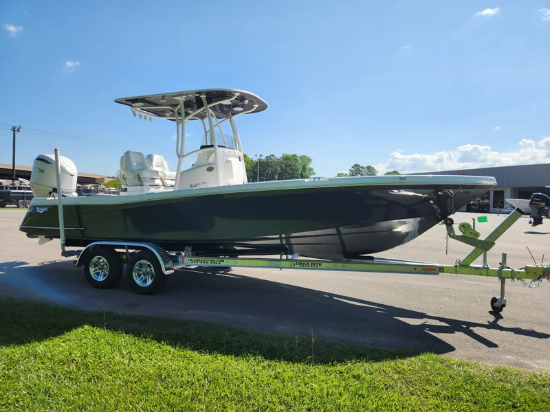 Slide: The Image of 2025 BlackJack 256 Coastal boat on trailer, parked outdoors under clear blue sky. - 6