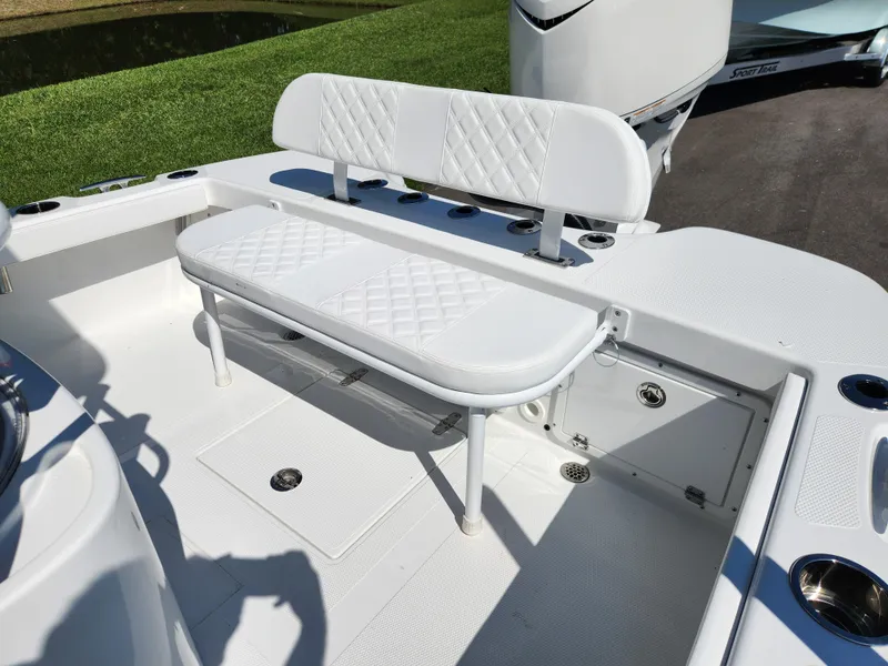 Slide: The Image of 2025 BlackJack 256 Coastal boat interior with white cushioned seating and storage compartments. - 8