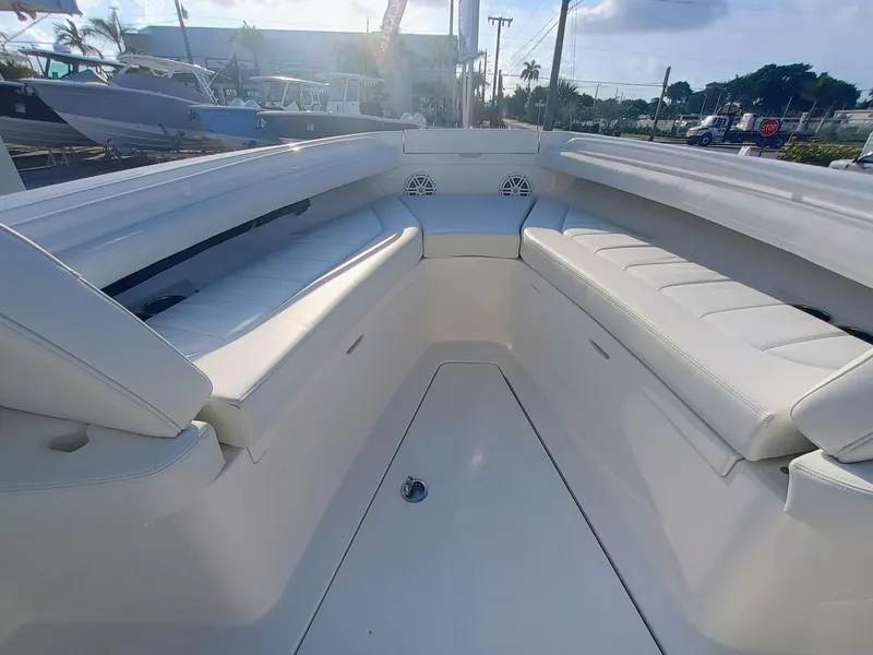 Slide: The Image of 2025 Regulator 23 Center Console boat interior with white seating and open deck. - 13