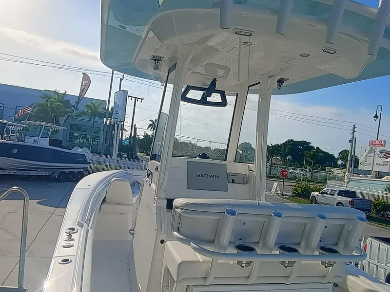 Slide: The Image of 2025 Regulator 23 Center Console boat with Garmin equipment, docked outdoors. - 16