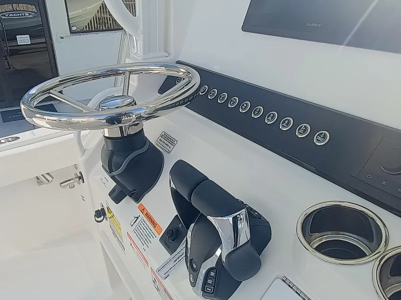 Slide: The Image of 2025 Regulator 23 Center Console boat helm with steering wheel and controls. - 20