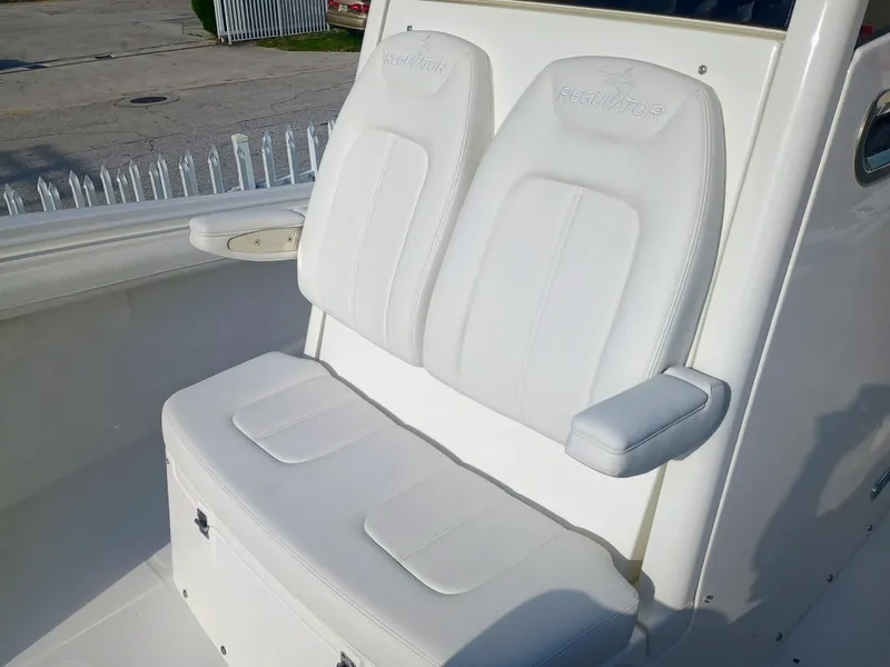Slide: The Image of 2025 Regulator 23 Center Console boat with white cushioned seating. - 38