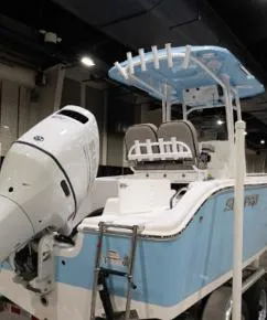 The Image of 2024 Sea Pro 222 Center Console boat with outboard motor, displayed indoors. - 1