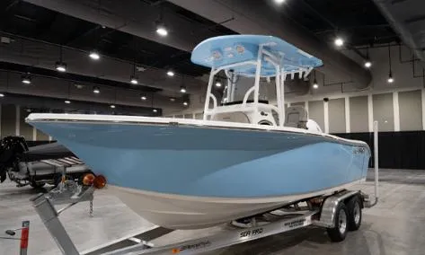 Slide: The Image of 2024 Sea Pro 222 Center Console boat on trailer in indoor showroom. - 2