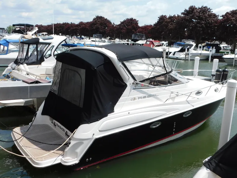 The Image of 2003 Regal 2860 Commodore boat docked in a marina with other vessels. - 0