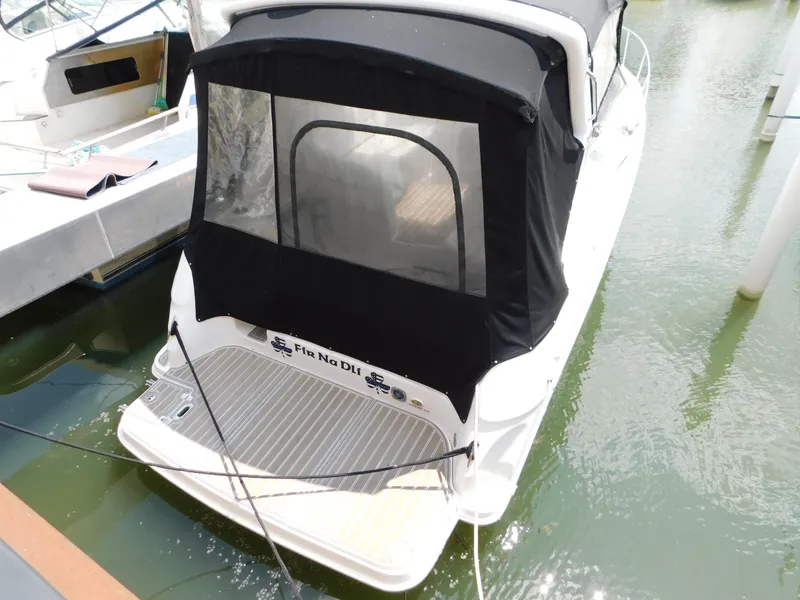 Slide: The Image of 2003 Regal 2860 Commodore boat docked with black canopy and swim platform. - 1