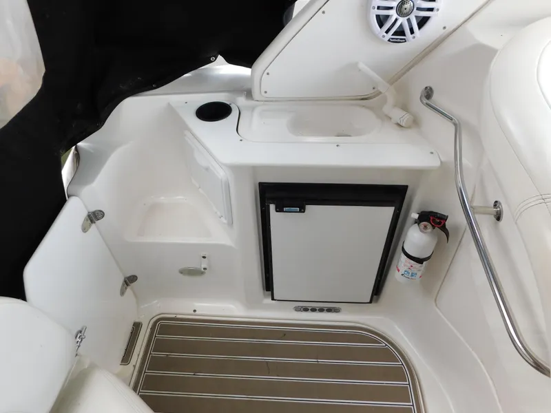 Slide: The Image of 2003 Regal 2860 Commodore boat interior with mini fridge and sink. - 11