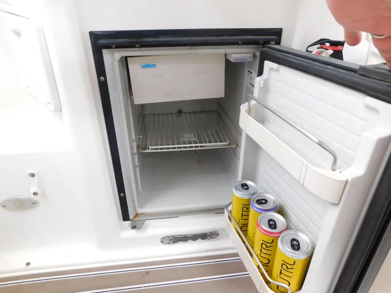 Slide: The Image of Open mini fridge on 2003 Regal 2860 Commodore boat with drinks inside. - 13