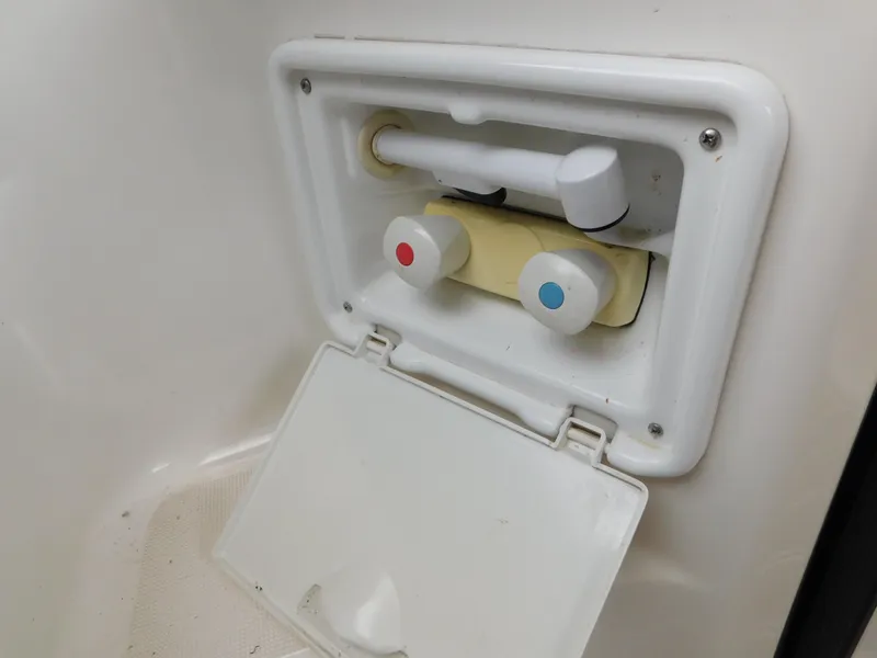 Slide: The Image of Water control panel on a 2003 Regal 2860 Commodore boat, featuring hot and cold knobs. - 15