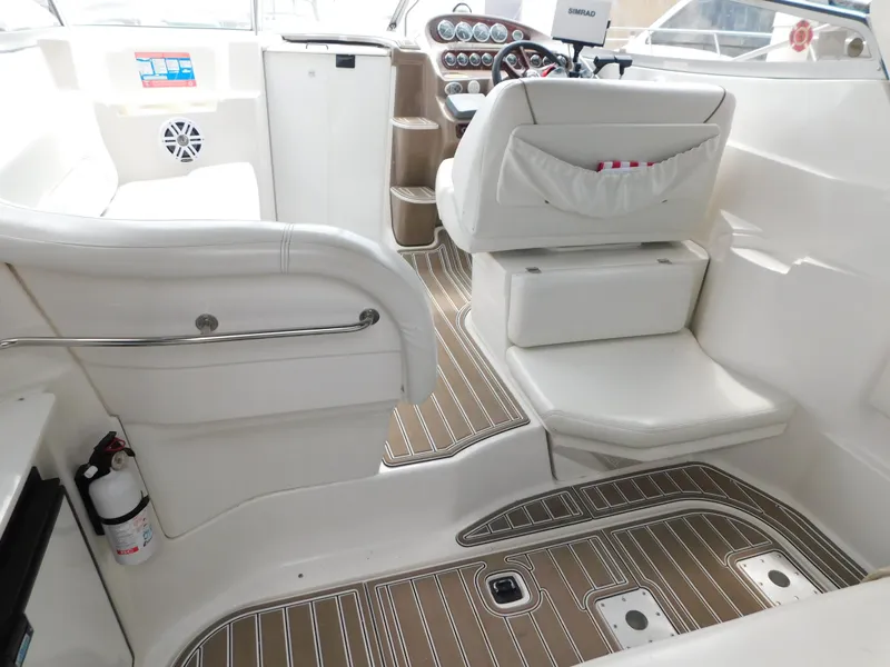 Slide: The Image of 2003 Regal 2860 Commodore boat interior with white seating and wood-patterned flooring. - 19