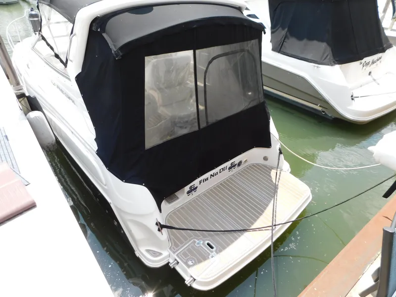 Slide: The Image of 2003 Regal 2860 Commodore boat docked with black canopy and swim platform. - 2