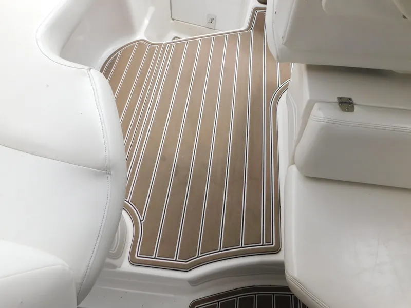 Slide: The Image of 2003 Regal 2860 Commodore boat interior with white seating and wood-patterned flooring. - 25