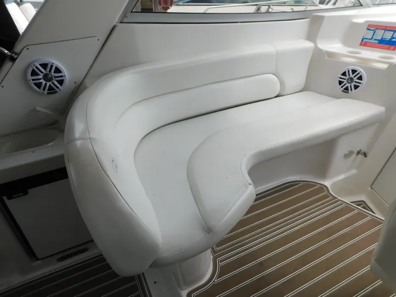 Slide: The Image of 2003 Regal 2860 Commodore boat interior with white seating and wood-patterned flooring. - 26