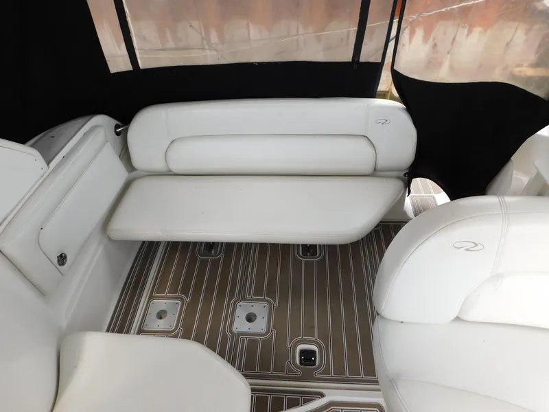 Slide: The Image of 2003 Regal 2860 Commodore boat interior with white seating and wood-patterned flooring. - 27
