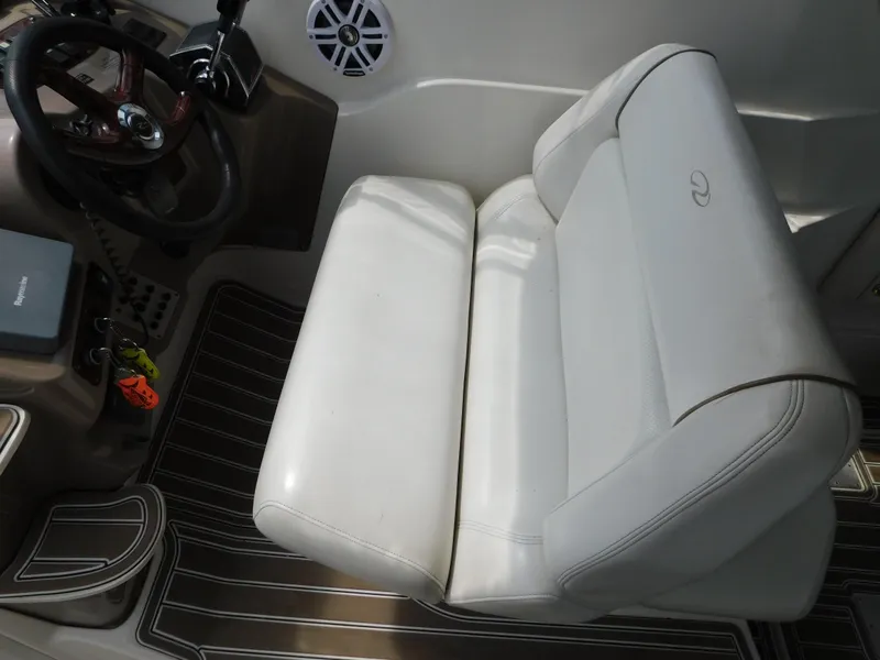 Slide: The Image of White leather seat in 2003 Regal 2860 Commodore boat cockpit, with steering wheel and speaker. - 28