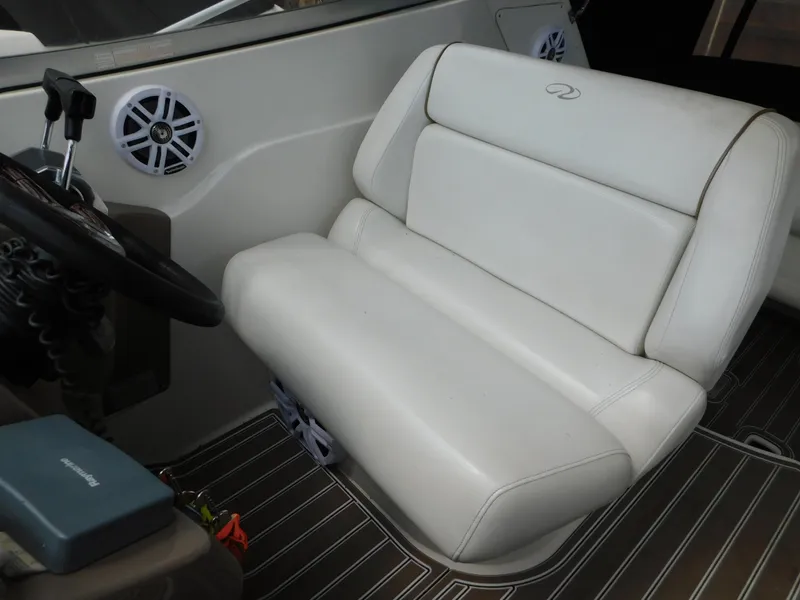 Slide: The Image of 2003 Regal 2860 Commodore boat interior with white leather seating and steering wheel. - 31