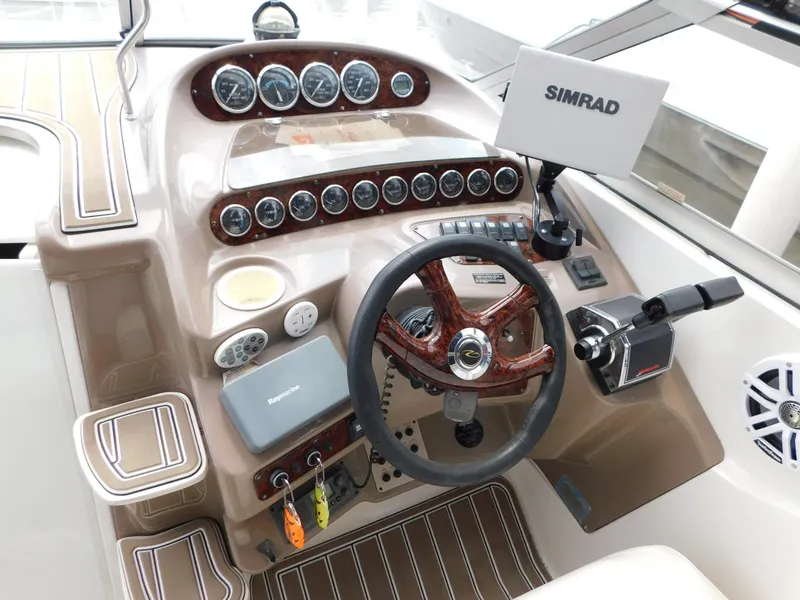 Slide: The Image of 2003 Regal 2860 Commodore boat dashboard with steering wheel and Simrad navigation system. - 32