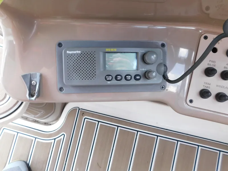 Slide: The Image of 2003 Regal 2860 Commodore boat dashboard with radio and control panel. - 37