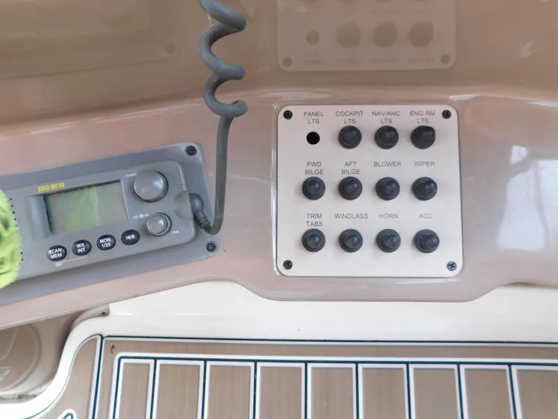 Slide: The Image of Control panel of a 2003 Regal 2860 Commodore boat with various switches and a radio. - 38