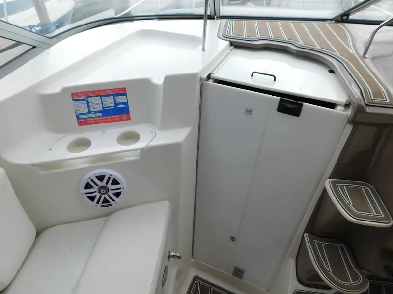 Slide: The Image of 2003 Regal 2860 Commodore boat interior with seating, speaker, and storage compartments. - 40