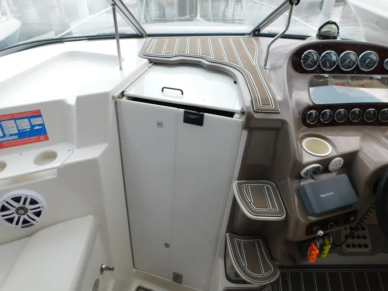 Slide: The Image of 2003 Regal 2860 Commodore boat cockpit with control panel and seating area. - 41