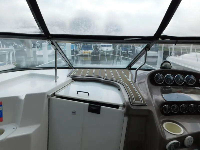 Slide: The Image of 2003 Regal 2860 Commodore boat cockpit with dashboard and marina view. - 42