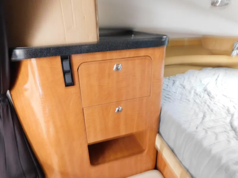 Slide: The Image of 2003 Regal 2860 Commodore cabin interior with wooden cabinetry and bed. - 45