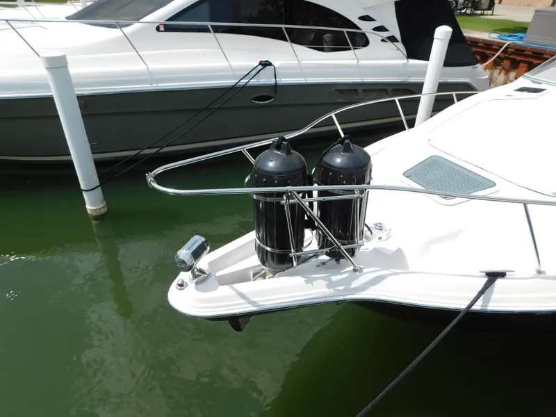 Slide: The Image of 2003 Regal 2860 Commodore boat docked, featuring dual fenders on the bow. - 5