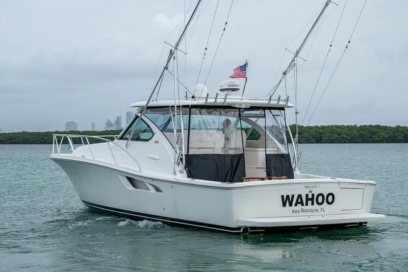 Slide: The Image of 2009 Tiara Yachts 39 Open boat on water, rear view with "WAHOO" name. - 12