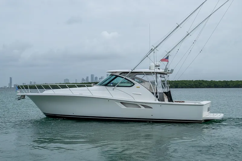 Slide: The Image of 2009 Tiara Yachts 39 Open cruising on calm waters with city skyline in background. - 13