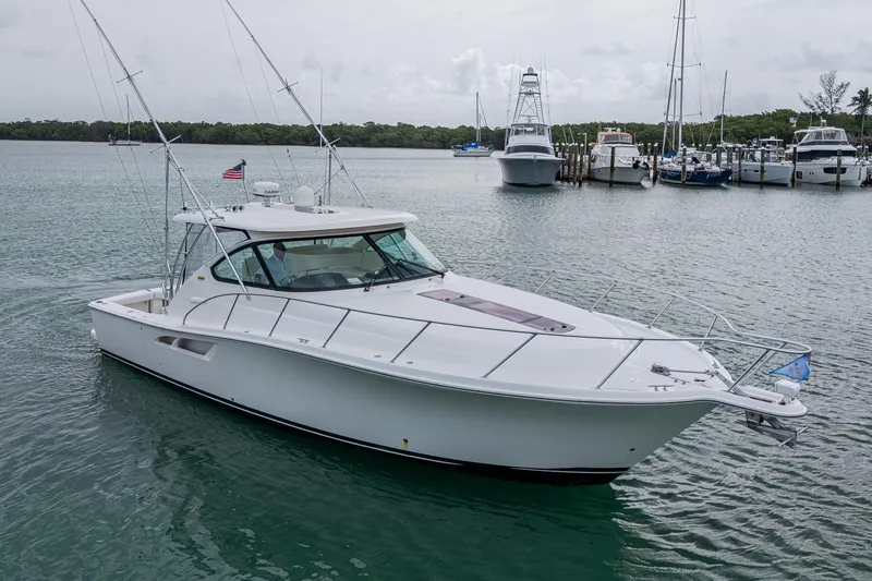 Slide: The Image of 2009 Tiara Yachts 39 Open in marina, sleek design, calm waters, overcast sky. - 14