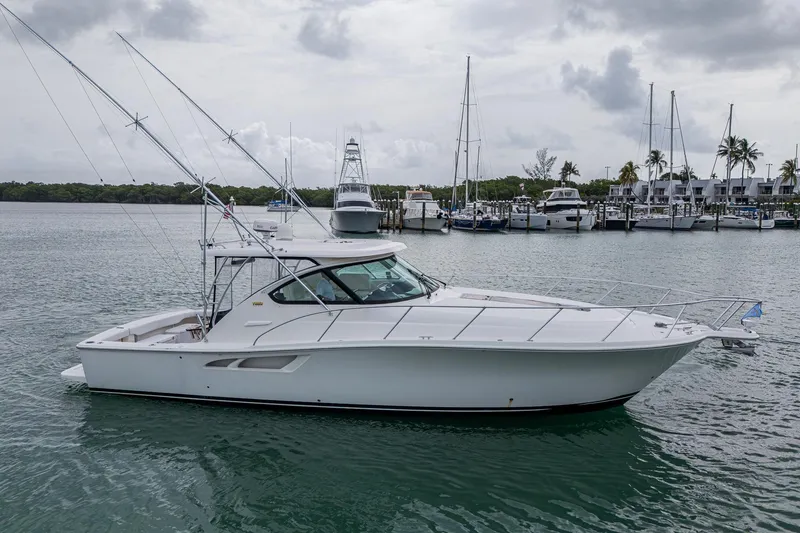 Slide: The Image of 2009 Tiara Yachts 39 Open boat docked in a marina, overcast sky. - 15
