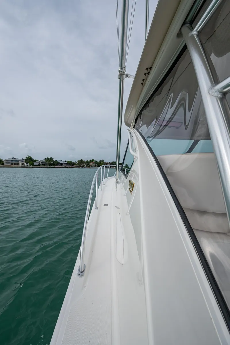 Slide: The Image of 2009 Tiara Yachts 39 Open, side view on water, showcasing sleek design and craftsmanship. - 24